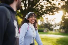 Female student smiling while walking on campus